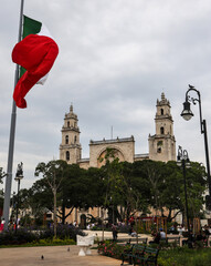 Mexico flag flying in wind at plaza grande (Merida, Yucatan peninsula) Mexican heritage state...