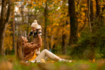 Mother and child enjoying a golden autumn day in a tranquil forest park
