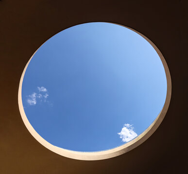 large open circular opening in a building with blue sky and clouds visible (modern architecture skylight) mexico window to outdoors