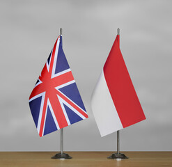 Table flags United Kingdom and Indonesia on grey blurred background