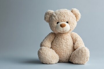 Obraz premium Soft plush bear on a pastel grey background creating a cozy atmosphere in a child's room