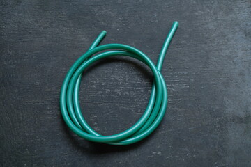 photo of a green water hose on a roll