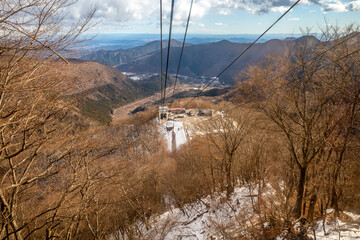 Akechidaira ropeway with surrounding beautiful viewpoints in Nikko, Japan, during cold weather in winter under cloudy blue sky