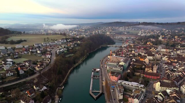 Aerial view of Schaffhausen, Switzerland, with Rhine River winding through historic city at sunrise, rooftops and golden light create breathtaking panorama. Luftaufnahme des Rheins in der Schweiz. 
