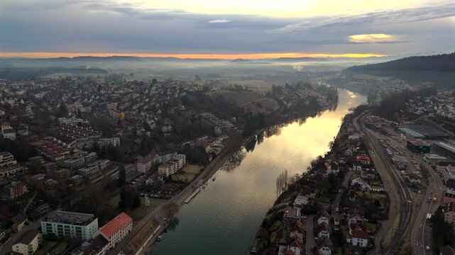 Aerial view of Schaffhausen, Switzerland, with Rhine River winding through historic city at sunrise, rooftops and golden light create breathtaking panorama. Luftaufnahme des Rheins in der Schweiz. 