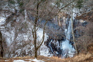 Kegon waterfall in Nikko, The UNESCO World Heritage city, Japan, became snow and ice in winter season under cloudy blue sky