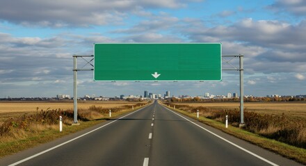 A straight road leading to a distant city under a green sign with a downward pointing arrow