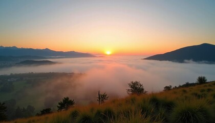 Obraz premium Breathtaking mountain sunrise above soft fog and lush meadows