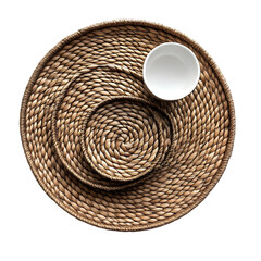Overhead shot of woven placemat with white bowl on a black background