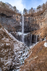 Kegon waterfall in Nikko, The UNESCO World Heritage city, Japan, became snow and ice in winter season under cloudy blue sky
