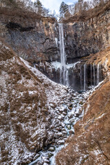 Kegon waterfall in Nikko, The UNESCO World Heritage city, Japan, became snow and ice in winter season under cloudy blue sky