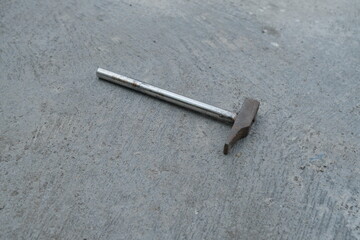 Photo of an iron hammer on the ground