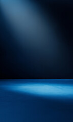Obraz premium The image displays a seamless gradient transitioning from a slightly lighter shade of deep blue at the bottom to a darker hue at the top. A subtle spotlight effect is visible, emanating from the top