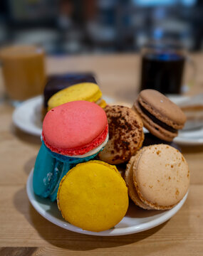 Delight in macaroon cookies, coffee, and chocolate cake at Amelie's French Bakery in Charlotte, North Carolina during a cozy afternoon visit