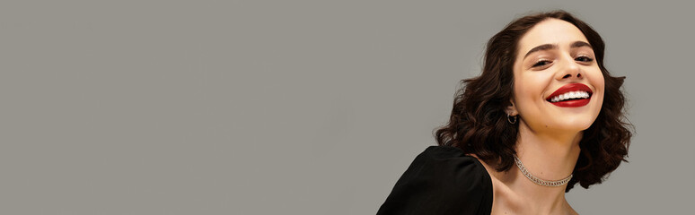 Smile brightens the grey background with youthful beauty