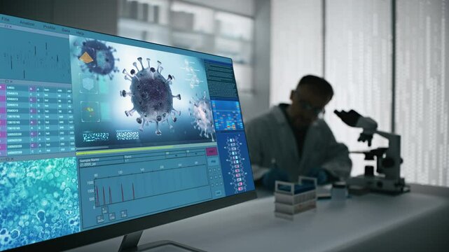 Male scientist working in a futuristic science laboratory with a microscope. Computer display showing bacteria mutation time lapse