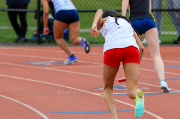 Track Athletes Compete in Sprint Relay Race During Afternoon Meet