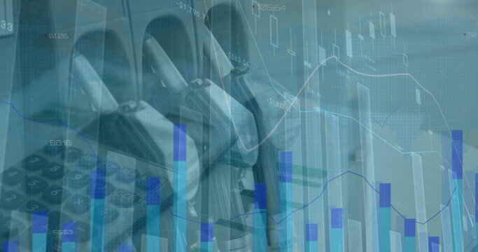 Image of statistics and financial data processing over calculator and petrol nozzles - Powered by Adobe