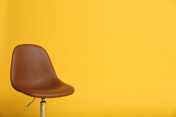 Modern office chair on yellow background. Space for text
