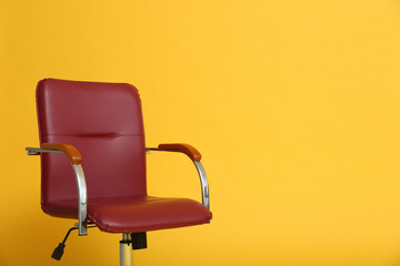 Modern office chair on yellow background. Space for text
