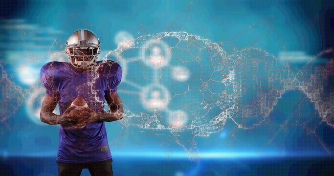 Image of digital brain spinning over male american football player holding ball - Powered by Adobe