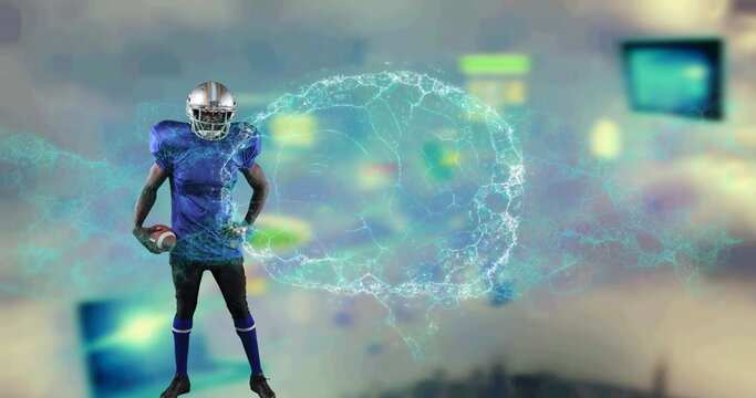 Image of digital brain spinning over male american football player holding ball