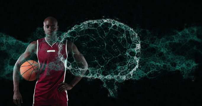Image of digital brain spinning over male basketball player holding ball