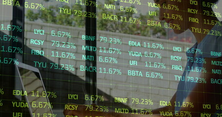 Image of statistics and data processing over woman using laptop