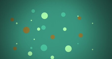 Image of multi coloured dots moving over green background