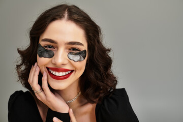 Beauty shines through with a radiant smile and stylish braces on a grey background