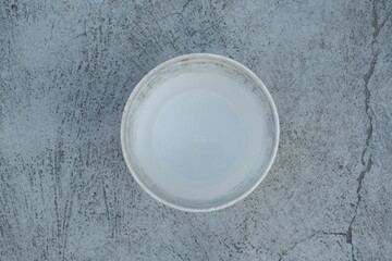 Photo of an empty white bucket on the ground