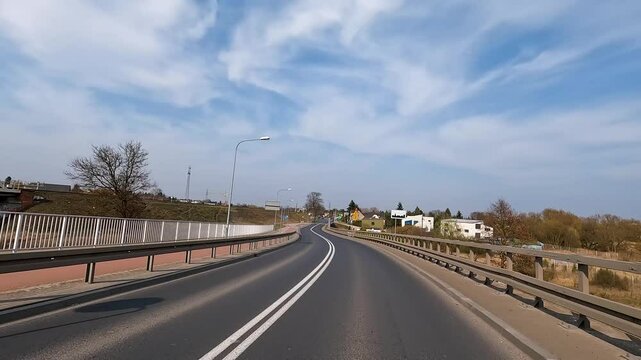 POV of a car driving fast on a paved road