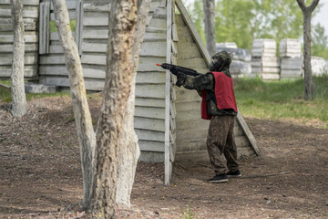 Kids playing airsoft. Team gun play on an outdoor sports field