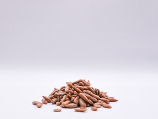 A pile of sunflower seeds, on a light background, front view