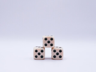 Three dice arranged in a pyramid, with a value of five, on a white background, front view, game, success, casino