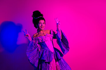 Elegant woman in vintage costume with pastel pink and blue neon lighting, displaying a royal and cheerful attitude