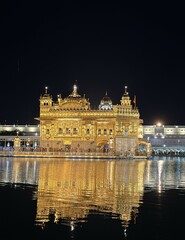 Golden Temple at night reflected in Amrit Sarovar, Amritsar, India.