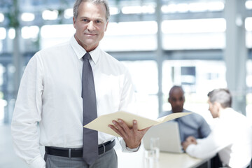 Portrait, lawyer and businessman with file in office, case document and legal research at law firm. Meeting, mature person and advocate with policy for corporate justice, ethical obligation or career