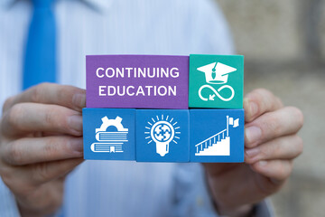 Business person hold colorful foam blocks with icons sees inscription: CONTINUING EDUCATION....