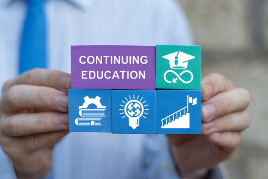 Business person hold colorful foam blocks with icons sees inscription: CONTINUING EDUCATION. Continuing education and personal development concept. Continuing professional education.