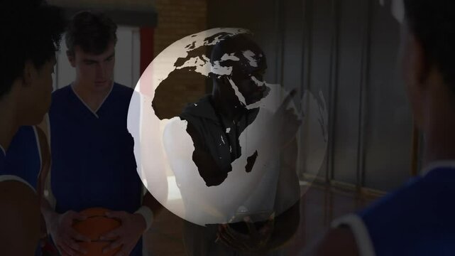 Basketball coach instructing team with rotating globe animation in school gym