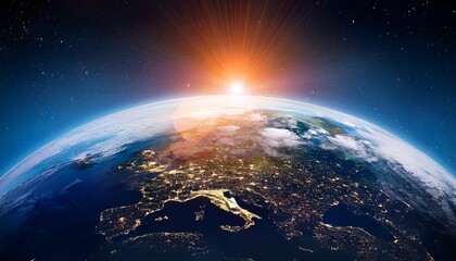 the earth from space at dawn with the sun peeking over the horizon