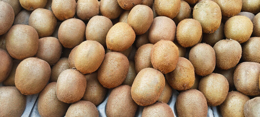 A pile of fresh kiwi fruits open sell in Indian market.