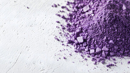 Fototapeta premium A close-up of Sumac powder in vibrant purple arranged neatly in a small heap on a white, smooth surface, highlighting its color and texture.