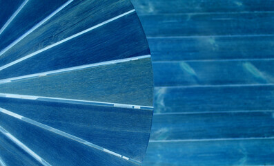 Part of a conical pattern on a blurred background with smooth elements with blue back lit 
