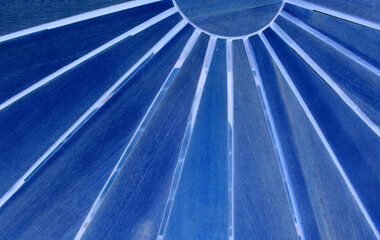 Blue geometrical pattern reminiscent of the sun with rays. Abstract design of blue elements
