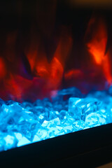 Electric fireplace with red flames and glowing blue crystals