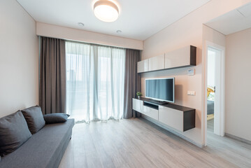 Modern Minimalist Home Living Room Interior with Sofa and Wall-Mounted Television Unit