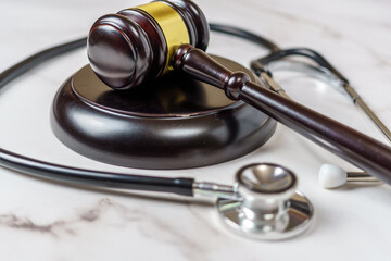 judge's gavel and a professional stethoscope representing legal decisions in health care. The...