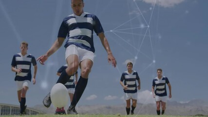 Kicking ball, soccer players in striped uniforms with network connections overlay - Powered by Adobe